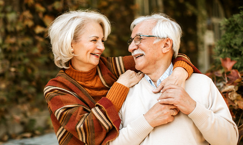 portrait of happy senior couple with their arms around each other