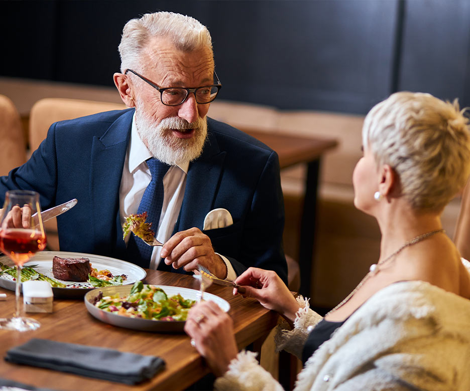 senior couple enjoying complimentary gourmet meal at a seminar about retirement made easy