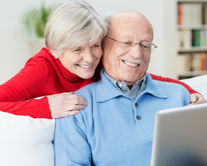 senior couple smiling at computer how fixed annuities work louisville KY evansville IL