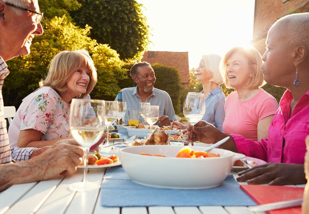 senior friends having a dinner party outside do i have enough to retire